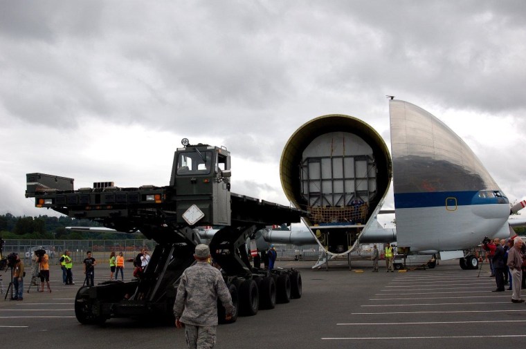 The 65,000-pound Tunner 60K aircraft cargo loader and transporter rolls toward the Super Guppy.