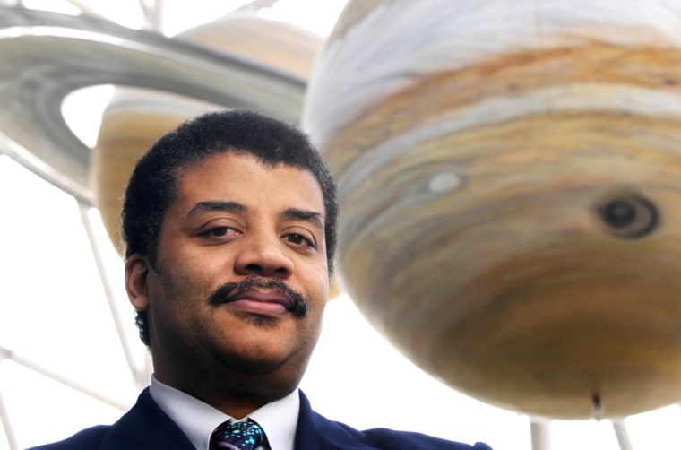 Astrophysicist Neil deGrasse Tyson, director of the Hayden Planetarium in New York City, is in his element among large-scale planetary models.