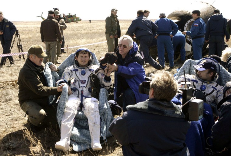 Billionaire space passenger Charles Simonyi, seated at left, and Russian cosmonaut Yuri Lonchakov rest after returning from the International Space Station in a Soyuz capsule.