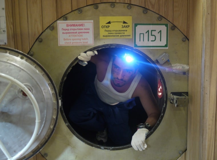 Diego Urbina, one of the six volunteers who have been cooped up in a Moscow lab during a 520-day simulated mission to Mars, looks out from a hatch inside the Mars500