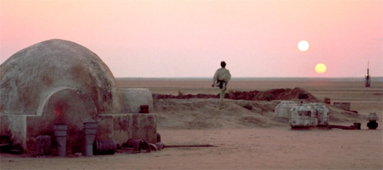 Luke Skywalker surveys a double sunset on the planet Tatooine in