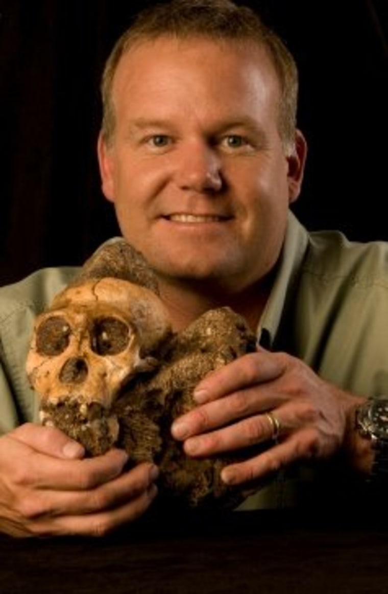 Anthropologist Lee Berger holds the cranium of Australopithecus sediba.