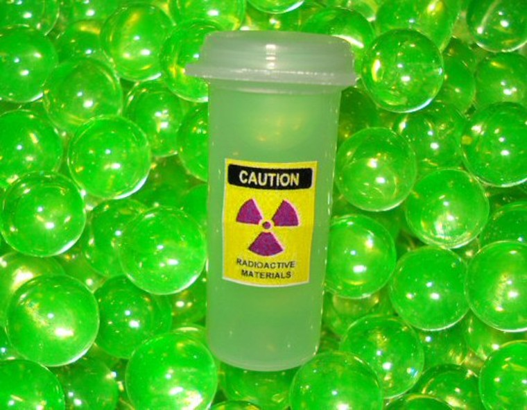 Uranium marbles glow with a greenish hue under ultraviolet light, but they're said to be safe — despite the radioactive sticker on the container.