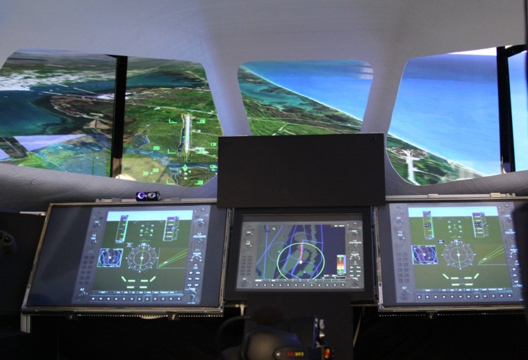 Sierra Nevada Corp.'s Dream Chaser flight simulator shows the view that would be outside the cockpit windows during the mini-shuttle's approach to a landing strip.