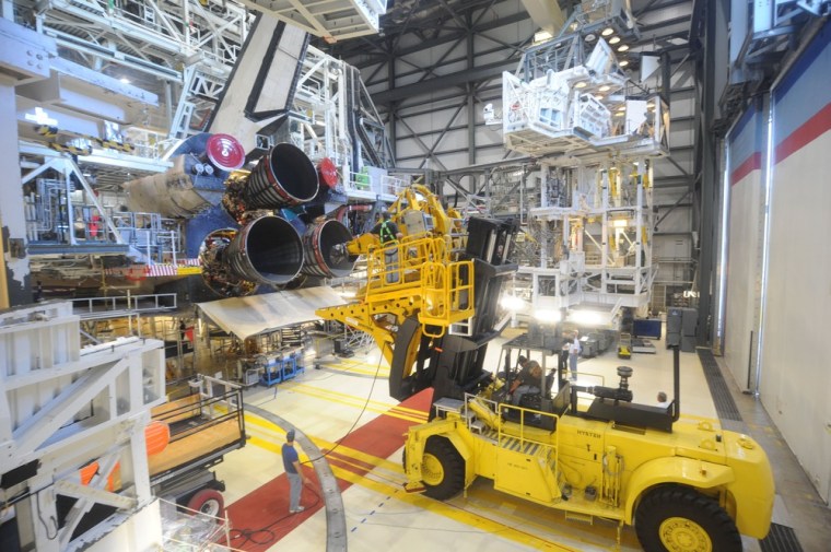 A wider view shows the space shuttle Atlantis inside the Orbiter Processing Facility.