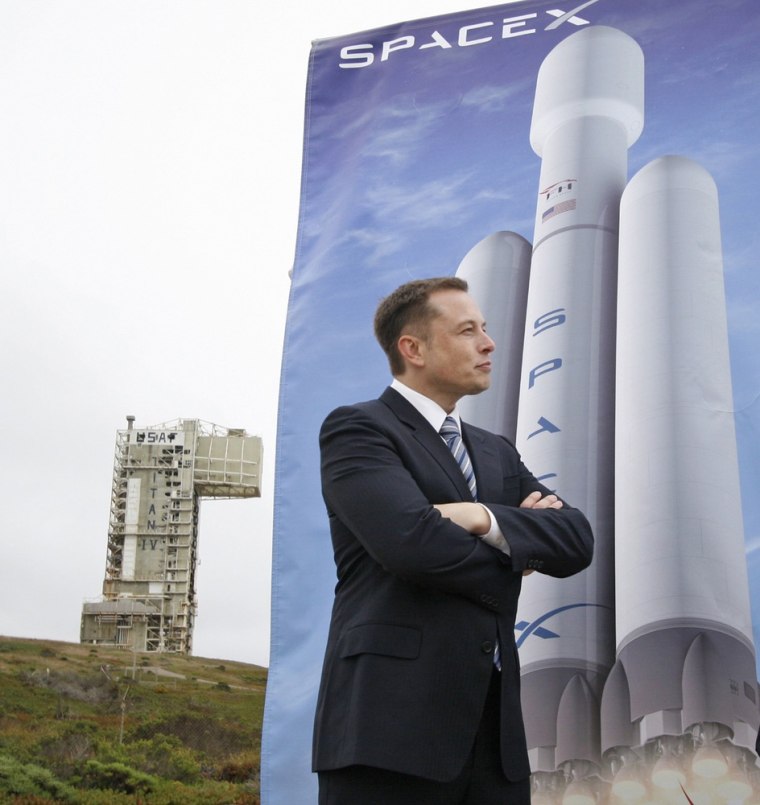 SpaceX CEO Elon Musk attends last month's groundbreaking ceremony at Vandenberg Air Force Base, with a launch pad and a picture of the Falcon Heavy rocket serving as a backdrop.