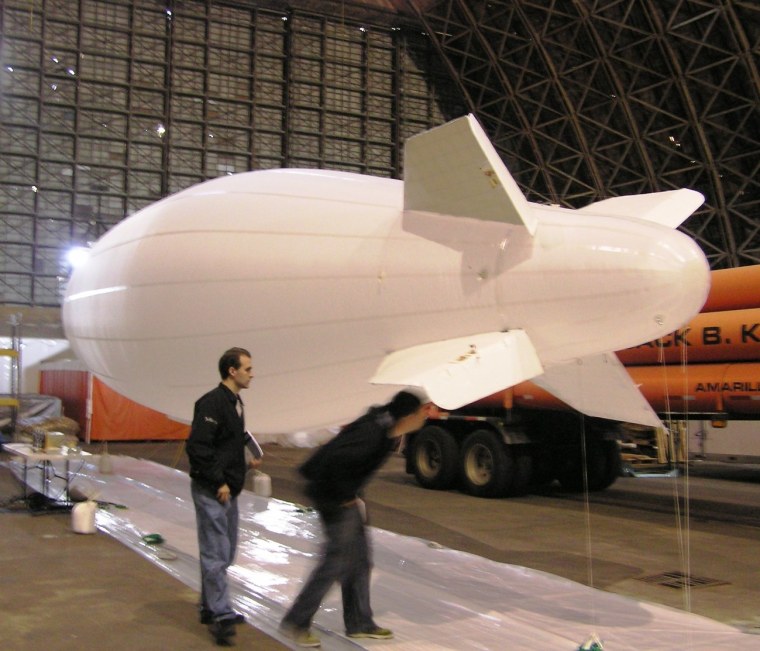 A test blimp for a future mission to Titan, designed by NASA's Jet Propulsion Laboratory and manufactured by Near Space Corp., floats inside the Tillamook Blimp Hangar in Oregon.