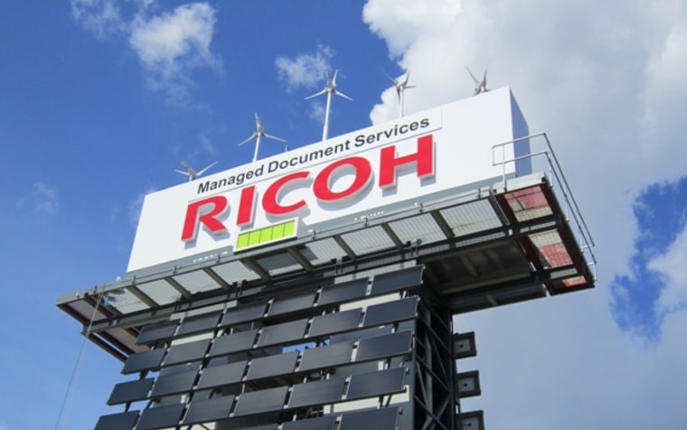 Ricoh unveiled a billboard Tuesday that is 100 percent powered by solar and wind energy.