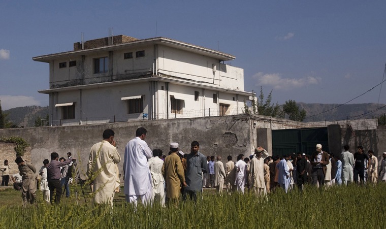 Pakistanis and international and local media gather outside Osama Bin Laden's compound, where he was killed during a raid by U.S. Special Forces on May 3 in Abottabad, Pakistan. Bin Laden was killed during a U.S. military mission May 2)
