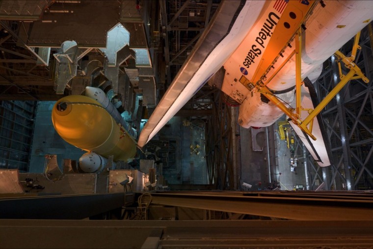 In one of 120,000 images shot during the time-lapse, NASA's space shuttle Atlantis is hoisted before being mounted with