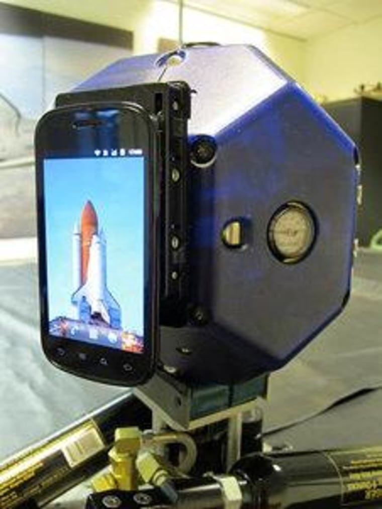 A prototype SPHERES satellite has a Samsung Nexus S attached to an expansion port.