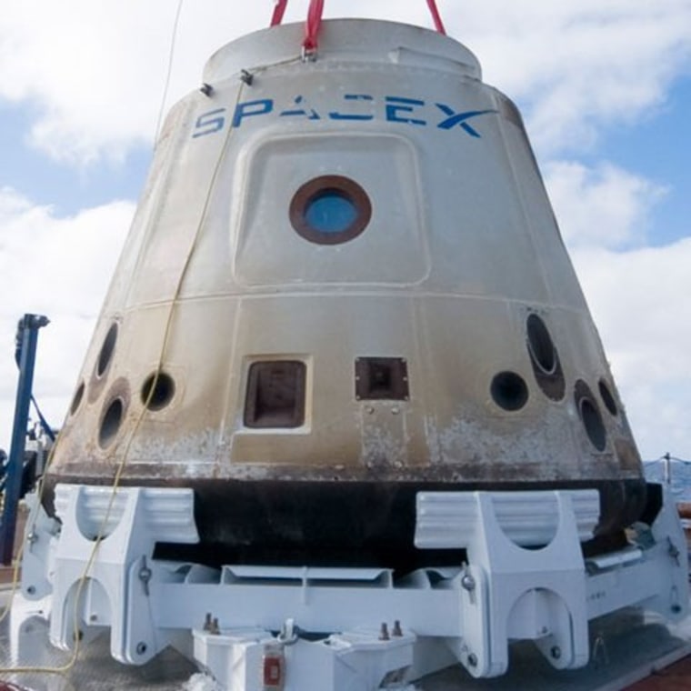 SpaceX's Dragon capsule sits on the deck of its recovery ship after its successful orbital flight in December.