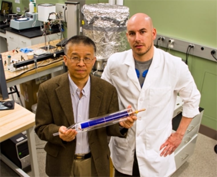 MIT doctoral student Daniel Kraemer, right, and Professor Gang Chen display a prototype of a flat-panel solar-thermoelectric generating device.