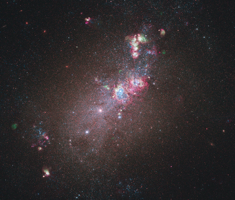 Galaxy NGC 4214, pictured here in an image from the NASA/ESA Hubble Space Telescope's newest camera, is an ideal location to study star formation and evolution. Dominating much of the galaxy is a huge glowing cloud of hydrogen gas in which new stars are being born.