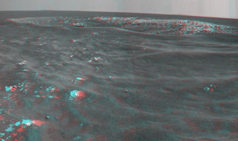 NASA's Opportunity rover recorded this stereo view of a Martian crater informally named Freedom 7. The mosaic image has been processed to fill gaps in coverage of the Martian sky. Use red-blue glasses to see the stereo effect, and click here for a bigger version.
