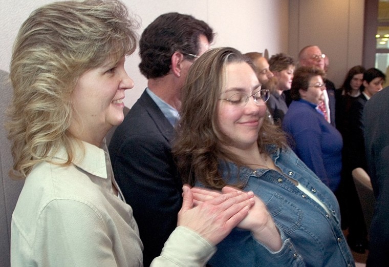 Tammy Kitzmiller, left, and Christy Rhem express their happiness during a news conference Tuesday, Dec. 20, 2005, in Harrisburg Pa., after hearing the verdicit from U.S. District Judge John E. Jones that prevents the Dover School District from teaching