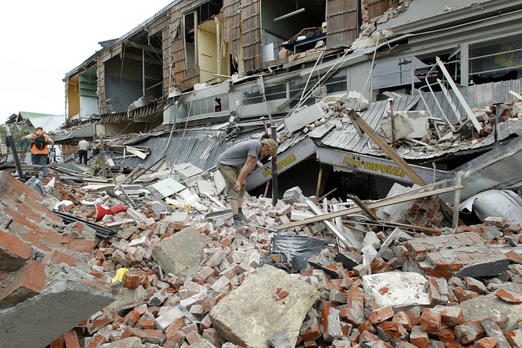 A man stands in remains of a building on February 22, 2011 in Christchurch, New Zealand. The 6.3 magnitude earthquake was an aftershock of the 7.1 magnitude quake on Sept. 4, 2010.
