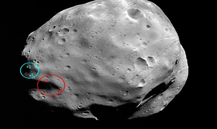 The ellipses on this image of Phobos show the previously planned landing area for the Phobos-Grunt mission in red, and the currently planned landing area in blue.