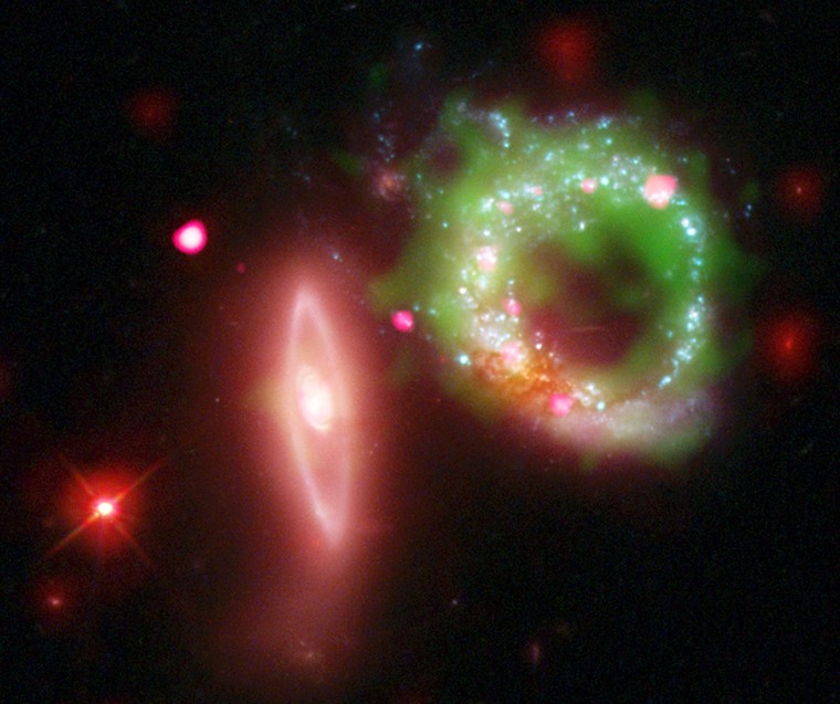 This composite image of Arp 147 shows Chandra X-ray data in pink, Hubble optical data in red, green and blue, ultraviolet GALEX data in green and infrared Spitzer data in red