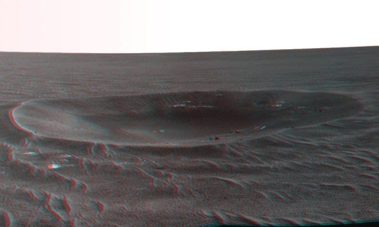 This stereo view of the Yankee Clipper crater on Mars is based on imagery sent back by NASA's Opportunity rover. Use red-blue glasses to get the 3-D effect. This larger version provides a better 3-D experience.