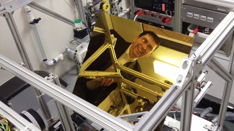 LaserMotive President Tom Nugent's reflected image shows up in a mirror that's part of the optics for the beam power system.