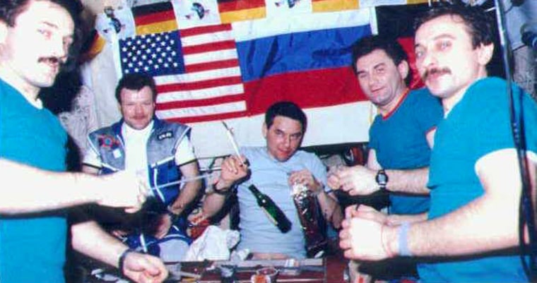 Cosmonauts gather to have some cognac on the Mir space station in 1997, hours after a flash fire nearly killed them. Alexander Lazutkin is at far right. The picture was taken by NASA astronaut Jerry Linenger, who passed up the opportunity to imbibe.