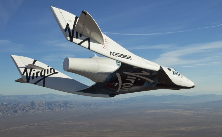 Virgin Galactic's SpaceShipTwo plane, also known as VSS Enterprise, glides earthward after its release from the White Knight Two mothership. The unpowered flight was piloted by Pete Siebold, an engineer and test pilot at Scaled Composites.