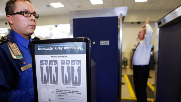 Transportation Security Administration screener Marlon Tejada, left, watches as Randy Parsons, the TSA's acting federal security director goes through a full-body X-ray scan today at Los Angeles International Airport.