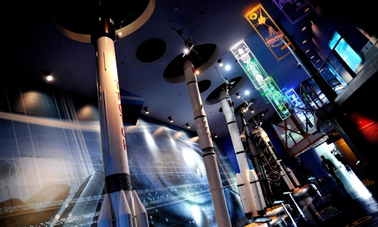 A visitor walks past rockets displayed at the Science and Technology Museum in Shanghai.