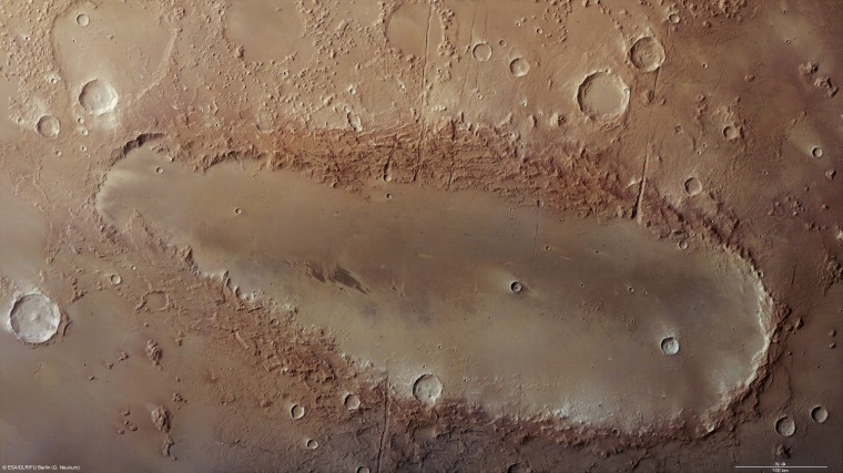 Orcus Patera, shown in this image from the European Space Agency's Mars Express orbiter, is an enigmatic elliptical depression located between the Martian volcanoes of Elysium Mons and Olympus Mons.