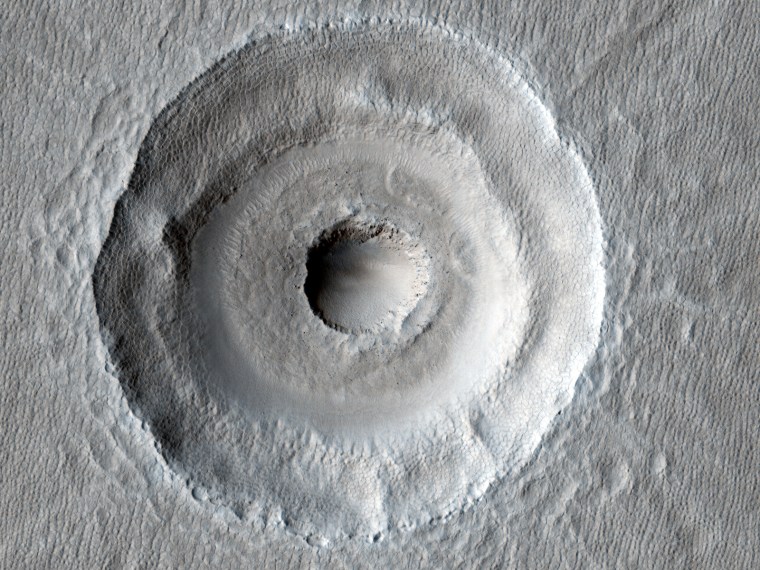 The central pit within this Martian crater may have been caused by unusual surface layering or a second impact.
