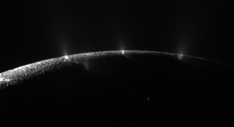 A backlit view of the Saturnian moon Enceladus, captured on Aug. 13, highlights geysers rising up from "tiger stripes."