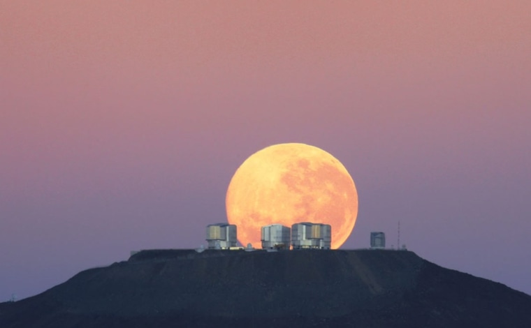 A full moon sets over the Very Large Telescope at the European Southern Observatory's Paranal Observatory in Chile.