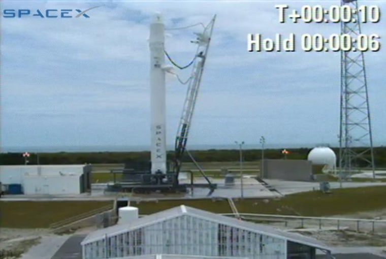 SpaceX's Falcon 9 rocket sits on its Cape Canaveral launch pad after today's last-second abort.