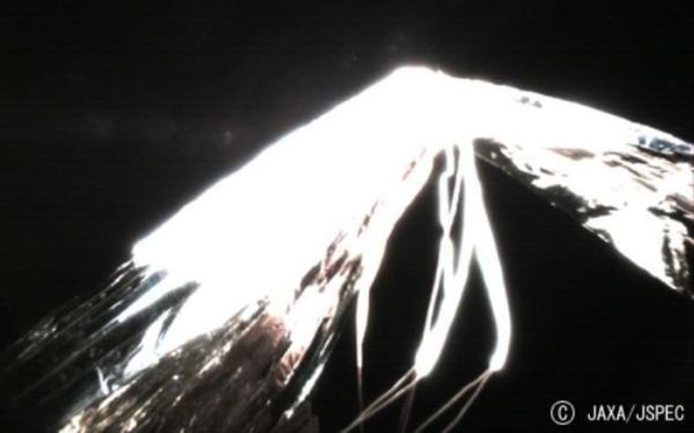 An image sent back from the Ikaros spacecraft shows a portion of its solar sail being unfurled.