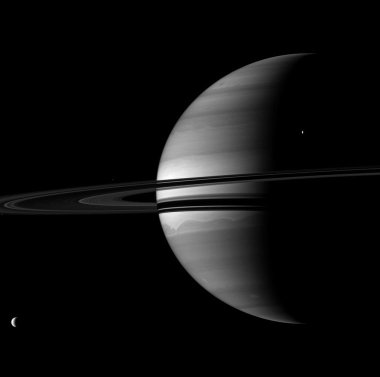 Four moons are visible in this portrait of Saturn and its rings, but two are so small you have to see the full-resolution view to spot them. Titan is at lower left, and Tethys is at upper right. The moon Pandora is a speck on the extreme left, just below the rings. Epimetheus is another speck, above the rings near the middle left. Look for all four moons in the enlarged picture.