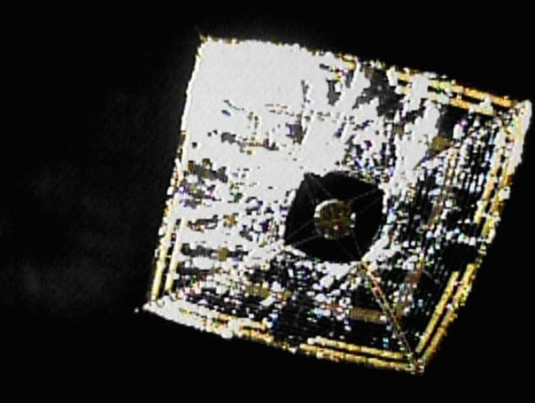 A camera that separated from Japan's Ikaros solar sail looks back to snap a picture of the fully deployed sail in outer space.