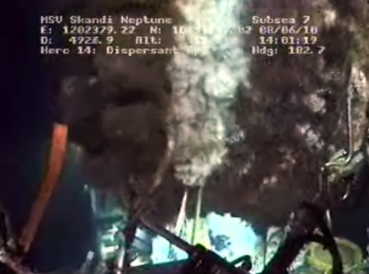 A deep-sea camera provides a view of dispersants (white plume) being applied to oil (dark plumes) leaking from the Deepwater Horizon well in the Gulf of Mexico. Closing down a cap on the well is the latest strategy to fight the leak.