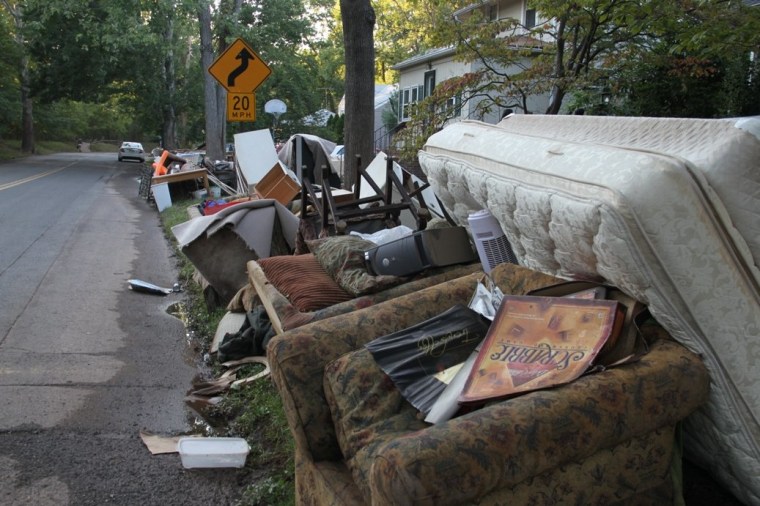 Cranford residents on Tuesday piled belongings destroyed by the flood on the curb or front lawn.