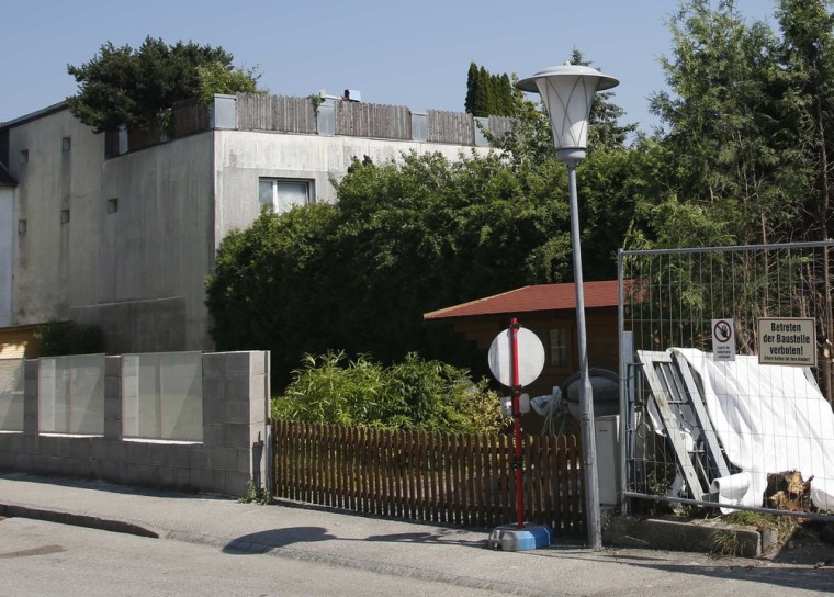 Building materials are seen in the garden of the house of Josef Fritzl, who kept his daughter captive for 24 years and fathered seven children in the cellar in the village of Amstetten Friday.