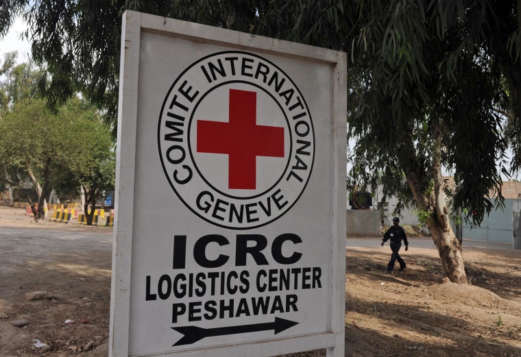 A private security guard walks past the office of the International Committee of the Red Cross (ICRC) in Peshawar, Pakistan, on May 10, 2012.