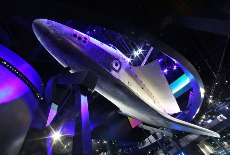 The space shuttle Atlantis is showcased as if it were in orbit on Thursday at its new $100 million home at Florida's Kennedy Space Center Vistor Complex.