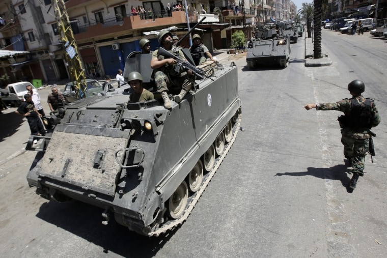 Lebanese army soldiers patrol Syria street in Tripoli's Sunni neighborhood of Bab al-Tabbaneh to restore a tense calm four hours after the clash broke out between Salafists who support the revolt in Syria and pro-Damascus fighters, on June 7, 2013 in Lebanon.