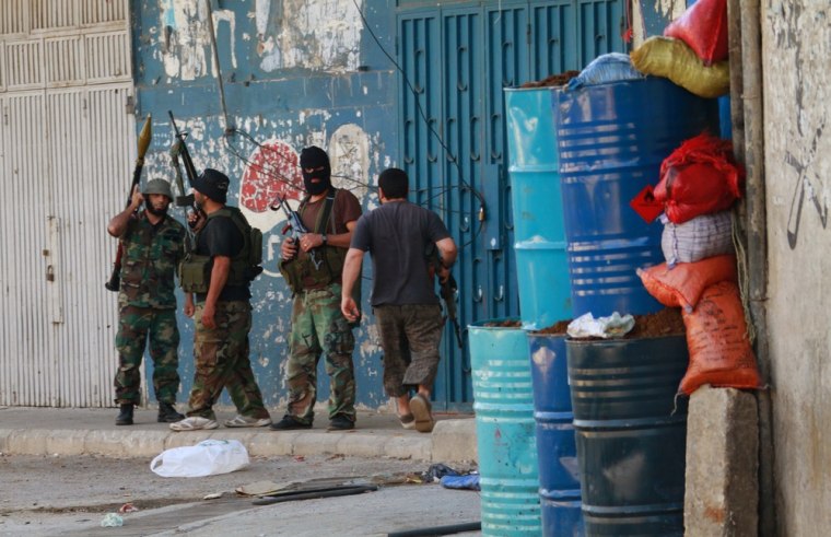 Lebanese Sunni gunmen take up position with their weapons in Bab Al Tabbaneh, a Sunni district, in the northern Lebanese town of Tripoli May 26, 2013.