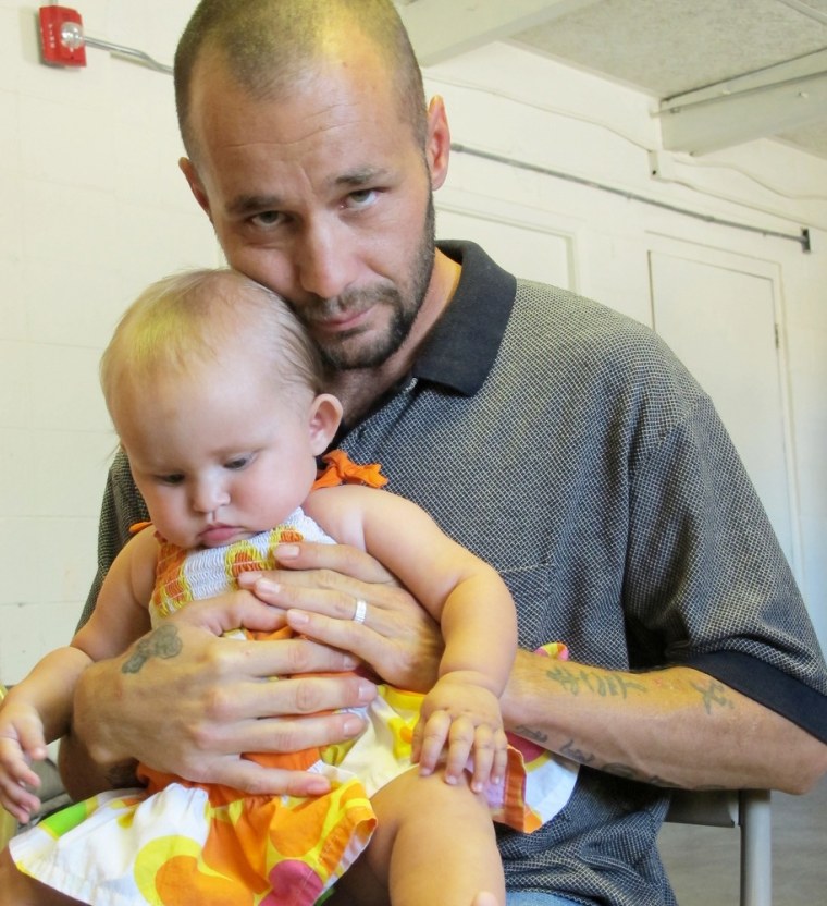 This June 20, 2013 image shows David Hutchinson and his daughter Navaeh posing for a photograph at Joy Junction homeless shelter in Albuquerque, N.M.
