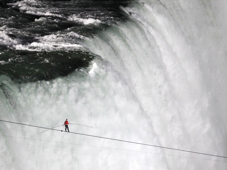 Tightrope walker Nik Wallenda walks the high wire from the U.S. side to the Canadian side over the Horseshoe Falls in Niagara Falls, Ontario, June 15,...
