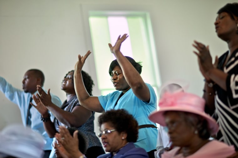 Donna Smith, a resident from the mainland who came over by ferry to attend the 129th anniversary of St. Luke Baptist Church, sings during the church's service on Sapelo Island on June 9.