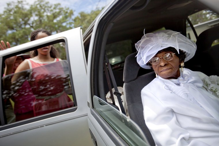 Cathleen Hillary, 93, the oldest resident of Sapelo Island, leaves a church service with her great granddaughter Milaika Ellison, for the 129th anniversary of St. Luke Baptist Church on the island on June 9.