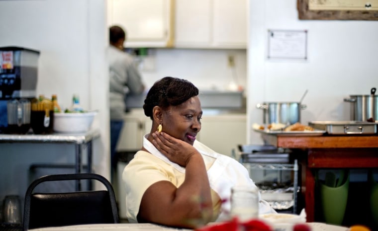 Lula Walker, 65, owner of Lula's Kitchen, rests after serving lunch to a tour group as her granddaughter Stephanie Grovner, 21, helps in the kitchen in the only restaurant in the Hog Hammock community of Sapelo Island on May 15.