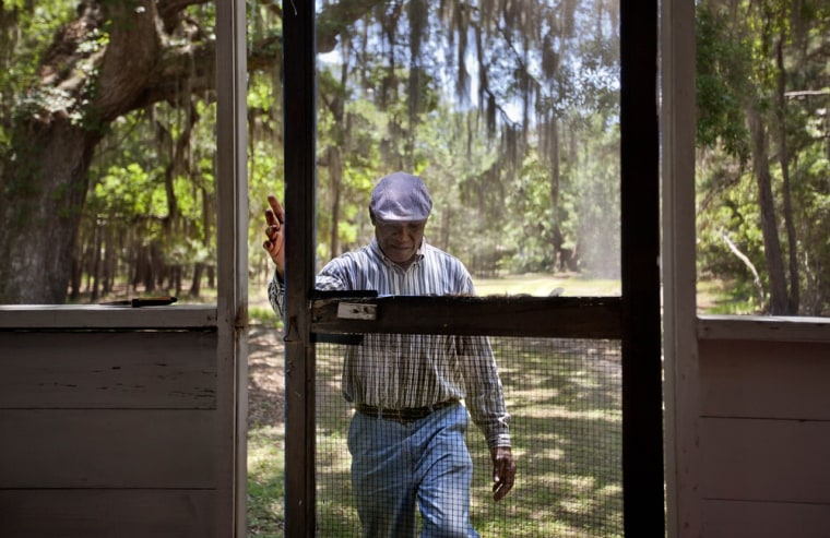 Stephen Wilson, 68, walks onto the front porch of his home that his father built in the Hog Hammock community of Sapelo Island on May 15.